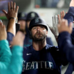 SEATTLE, WASHINGTON - SEPTEMBER 26: Mike Ford #20 of the Seattle Mariners celebrates a run during the third inning against the Houston Astros at T-Mobile Park on September 26, 2023 in Seattle, Washington. (Photo by Steph Chambers/Getty Images)