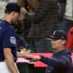 SEATTLE, WASHINGTON - SEPTEMBER 26: Manager Scott Servais #9 fist bumps George Kirby #68 of the Seattle Mariners during the first inning against the Houston Astros at T-Mobile Park on September 26, 2023 in Seattle, Washington. (Photo by Steph Chambers/Getty Images)