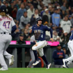 SEATTLE, WASHINGTON - SEPTEMBER 26: Josh Rojas #4 of the Seattle Mariners scores a run during the fifth inning against the Houston Astros at T-Mobile Park on September 26, 2023 in Seattle, Washington. (Photo by Steph Chambers/Getty Images)