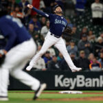 SEATTLE, WASHINGTON - SEPTEMBER 26: Eugenio Suarez #28 of the Seattle Mariners makes a leaping throw during the ninth inning against the Houston Astros at T-Mobile Park on September 26, 2023 in Seattle, Washington. (Photo by Steph Chambers/Getty Images)