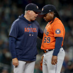 SEATTLE, WASHINGTON - SEPTEMBER 27: Pitching coach 	Joshua Miller talks with Framber Valdez #59 of the Houston Astros after giving up a home run during the first inning against the Seattle Mariners at T-Mobile Park on September 27, 2023 in Seattle, Washington. (Photo by Steph Chambers/Getty Images)