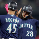 SEATTLE, WASHINGTON - SEPTEMBER 27: Eugenio Suarez #28 of the Seattle Mariners celebrates his two-run RBI single with first base coach Kristopher Negrón #45 during the fourth inning against the Houston Astros at T-Mobile Park on September 27, 2023 in Seattle, Washington. (Photo by Steph Chambers/Getty Images)