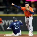 SEATTLE, WASHINGTON - SEPTEMBER 27: Jeremy Pena #3 of the Houston Astros turns a double play over Ty France #23 of the Seattle Mariners during the fifth inning at T-Mobile Park on September 27, 2023 in Seattle, Washington. (Photo by Steph Chambers/Getty Images)