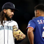 SEATTLE, WASHINGTON - SEPTEMBER 28: J.P. Crawford #3 of the Seattle Mariners and Marcus Semien #2 of the Texas Rangers greet each other during the first inning at T-Mobile Park on September 28, 2023 in Seattle, Washington. (Photo by Steph Chambers/Getty Images)