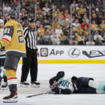 LAS VEGAS, NEVADA - OCTOBER 10: Brandon Tanev #13 of the Seattle Kraken lies on the ice after taking an illegal check to the head from Brett Howden #21 of the Vegas Golden Knights in the third period of their game at T-Mobile Arena on October 10, 2023 in Las Vegas, Nevada. Howden received a match penalty for the hit. The Golden Knights defeated the Kraken 4-1. (Photo by Ethan Miller/Getty Images)