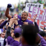 SEATTLE, WASHINGTON - OCTOBER 14: Rome Odunze #1 of the Washington Huskies celebrates as fans storm the field after the Washington Huskies beat the Oregon Ducks 36-33 at Husky Stadium on October 14, 2023 in Seattle, Washington. (Photo by Steph Chambers/Getty Images)