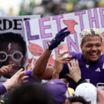 SEATTLE, WASHINGTON - OCTOBER 14: Rome Odunze #1 of the Washington Huskies celebrates as fans storm the field after the Washington Huskies beat the Oregon Ducks 36-33 at Husky Stadium on October 14, 2023 in Seattle, Washington. (Photo by Steph Chambers/Getty Images)
