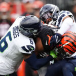CINCINNATI, OHIO - OCTOBER 15: Ja'Marr Chase #1 of the Cincinnati Bengals is tackled by Quandre Diggs #6 and Julian Love #20 of the Seattle Seahawks during the second quarter at Paycor Stadium on October 15, 2023 in Cincinnati, Ohio. (Photo by Dylan Buell/Getty Images)