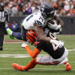 CINCINNATI, OHIO - OCTOBER 15: DK Metcalf #14 of the Seattle Seahawks catches a pass and is tackled by Cam Taylor-Britt #29 of the Cincinnati Bengals during the fourth quarter at Paycor Stadium on October 15, 2023 in Cincinnati, Ohio. (Photo by Dylan Buell/Getty Images)