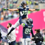 SEATTLE, WASHINGTON - OCTOBER 22: Jake Bobo #19 of the Seattle Seahawks celebrates after scoring a touchdown with Will Dissly #89 of the Seattle Seahawks in the second quarter of the game against the Arizona Cardinals at Lumen Field on October 22, 2023 in Seattle, Washington. (Photo by Jane Gershovich/Getty Images)