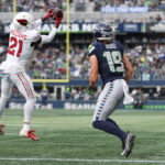 SEATTLE, WASHINGTON - OCTOBER 22: Garrett Williams #21 of the Arizona Cardinals intercepts the pass to Jake Bobo #19 of the Seattle Seahawks during the third quarter of the game at Lumen Field on October 22, 2023 in Seattle, Washington. (Photo by Steph Chambers/Getty Images)
