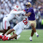 SEATTLE, WASHINGTON - NOVEMBER 11: Dillon Johnson #7 of the Washington Huskies carries the ball against the Utah Utes during the first quarter at Husky Stadium on November 11, 2023 in Seattle, Washington. (Photo by Steph Chambers/Getty Images)