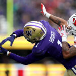 SEATTLE, WASHINGTON - NOVEMBER 11: Rome Odunze #1 of the Washington Huskies can't pull in a catch against JaTravis Broughton #4 of the Utah Utes during the second quarter at Husky Stadium on November 11, 2023 in Seattle, Washington. (Photo by Steph Chambers/Getty Images)