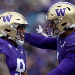 SEATTLE, WASHINGTON - NOVEMBER 11: Michael Penix Jr. #9 and Rome Odunze #1 of the Washington Huskies celebrate their touchdown against the Utah Utes during the third quarter at Husky Stadium on November 11, 2023 in Seattle, Washington. (Photo by Steph Chambers/Getty Images)