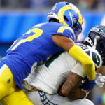 INGLEWOOD, CALIFORNIA - NOVEMBER 19: Jaxon Smith-Njigba #11 of the Seattle Seahawks is tackled by Quentin Lake #37 of the Los Angeles Rams during the first quarter at SoFi Stadium on November 19, 2023 in Inglewood, California. (Photo by Ronald Martinez/Getty Images)