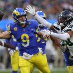 INGLEWOOD, CALIFORNIA - NOVEMBER 19: Matthew Stafford #9 of the Los Angeles Rams throws the ball while under pressure from Julian Love #20 of the Seattle Seahawks during the second quarter at SoFi Stadium on November 19, 2023 in Inglewood, California. (Photo by Sean M. Haffey/Getty Images)