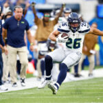 INGLEWOOD, CALIFORNIA - NOVEMBER 19: Zach Charbonnet #26 of the Seattle Seahawks runs with the ball in the game against the Los Angeles Rams during the third quarter at SoFi Stadium on November 19, 2023 in Inglewood, California. (Photo by Ronald Martinez/Getty Images)