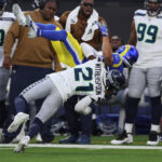 INGLEWOOD, CALIFORNIA - NOVEMBER 19: Devon Witherspoon #21 of the Seattle Seahawks tackles Austin Trammell #81 of the Los Angeles Rams and is called for unnecessary roughness during the fourth quarter at SoFi Stadium on November 19, 2023 in Inglewood, California. (Photo by Sean M. Haffey/Getty Images)