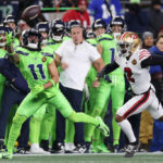 SEATTLE, WASHINGTON - NOVEMBER 23: Jaxon Smith-Njigba #11 of the Seattle Seahawks hauls in a one-handed catch in front of Deommodore Lenoir #2 of the San Francisco 49ers during the third quarter at Lumen Field on November 23, 2023 in Seattle, Washington. (Photo by Steph Chambers/Getty Images)