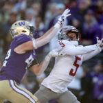 SEATTLE, WASHINGTON - NOVEMBER 25: Lincoln Victor #5 of the Washington State Cougars can't make a catch against Carson Bruener #42 of the Washington Huskies during the second quarter at Husky Stadium on November 25, 2023 in Seattle, Washington. (Photo by Steph Chambers/Getty Images)