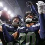 Julian Love of the Seattle Seahawks celebrates with teammates on Dec. 18, 2023. (Steph Chambers/Getty Images)