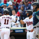 MINNEAPOLIS, MN - APRIL 10: Jorge Polanco #11 of the Minnesota Twins celebrates his solo home run with Gio Urshela #15 while Luis Torrens #22 of the Seattle Mariners reacts in the fourth inning of the game at Target Field on April 10, 2022 in Minneapolis, Minnesota. The Twins defeated the Mariners 10-4. (Photo by David Berding/Getty Images)