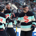 SEATTLE, WASHINGTON - JANUARY 01:  Will Borgen #3 of the Seattle Kraken is congratulated by Tye Kartye #52 and Jamie Oleksiak #24 after scoring a goal against the Vegas Golden Knights during the second period at T-Mobile Park on January 01, 2024 in Seattle, Washington. (Photo by Steph Chambers/Getty Images)
