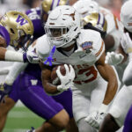 NEW ORLEANS, LOUISIANA - JANUARY 01:  Jaydon Blue #23 of the Texas Longhorns carries the ball during the first quarter against the Washington Huskies during the CFP Semifinal Allstate Sugar Bowl at Caesars Superdome on January 01, 2024 in New Orleans, Louisiana. (Photo by Sean Gardner/Getty Images)
