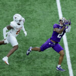 NEW ORLEANS, LOUISIANA - JANUARY 01: Ja'Lynn Polk #2 of the Washington Huskies catches a pass against Terrance Brooks #8 of the Texas Longhorns during the first quarter during the CFP Semifinal Allstate Sugar Bowl at Caesars Superdome on January 01, 2024 in New Orleans, Louisiana. (Photo by Jonathan Bachman/Getty Images)