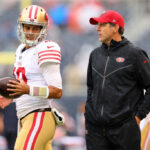 CHICAGO, ILLINOIS - SEPTEMBER 11: Jimmy Garoppolo #10 of the San Francisco 49ers talks with quarterbacks coach Brian Griese prior to the game against the Chicago Bears at Soldier Field on September 11, 2022 in Chicago, Illinois. (Photo by Michael Reaves/Getty Images)