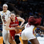 ALBANY, NEW YORK - MARCH 29: Mackenzie Holmes #54 of the Indiana Hoosiers drives against Kamilla Cardoso #10 and Raven Johnson #25 of the South Carolina Gamecocks during the second half in the Sweet 16 round of the NCAA Women's Basketball Tournament at MVP Arena on March 29, 2024 in Albany, New York. (Photo by Sarah Stier/Getty Images)