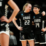 PORTLAND, OREGON - MARCH 29: Brynna Maxwell #22 and Kaylynne Truong #14 of the Gonzaga Bulldogs talk during the second half against the Texas Longhorns in the Sweet 16 round of the NCAA Women's Basketball Tournament at Moda Center on March 29, 2024 in Portland, Oregon. (Photo by Soobum Im/Getty Images)