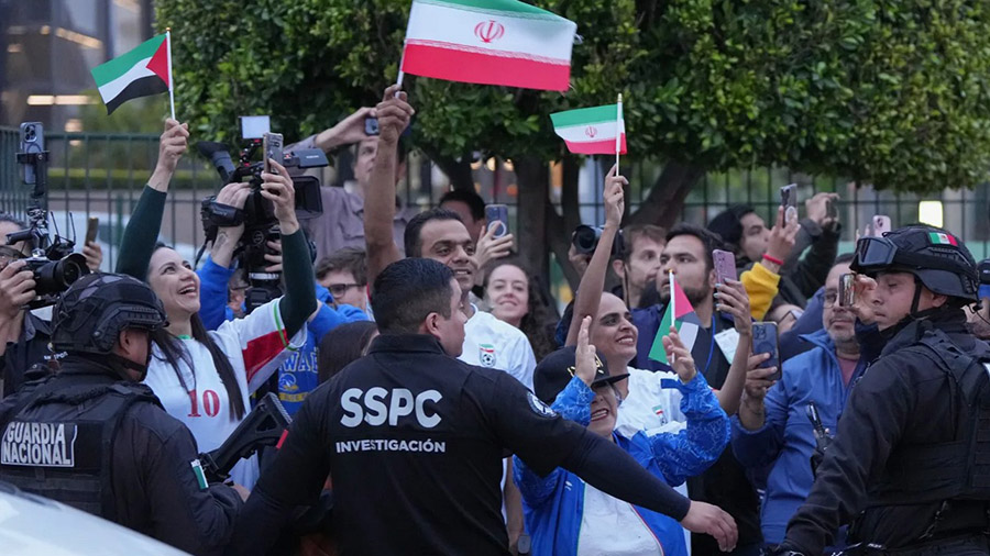 Fans of the Iran soccer team wave as players arrive for the World Cup in Tijuana, Mexico on June 7,...