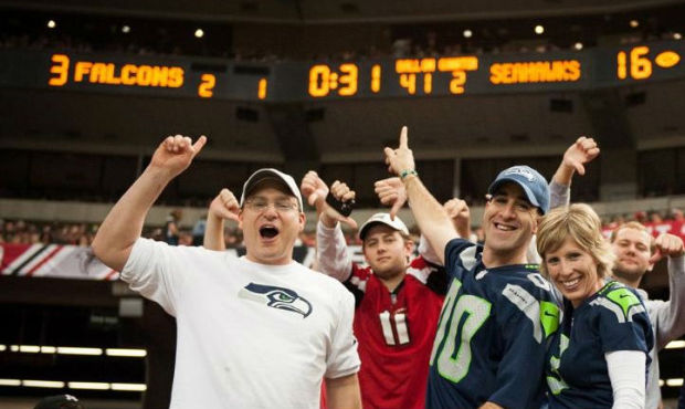 Seahawks fan Michael Stentz Jr. (l) celebrates the Seahawks 33-10 win over the Falcons in Atlanta l...