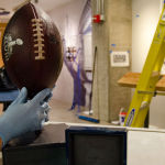 A football and ring from Super Bowl XLVIII are among the artifacts that will be on display in the new EMP Museum exhibition staff prepare the Lombardi Trophy for display in the new exhibition "We Are 12: The Seattle Seahawks and the Road to Victory."