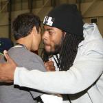 Seahawks defensive back Richard Sherman gives a hug to one of the players on the Marysville-Pilchuck football team.