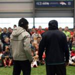 Members of the Seahawks speak with players from Marysville-Pilchuck High School Tuesday.