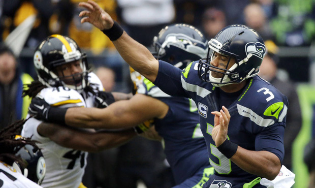 Russell Wilson threw five touchdowns on the same day he woke up ill and needed three IV drips. (AP)...