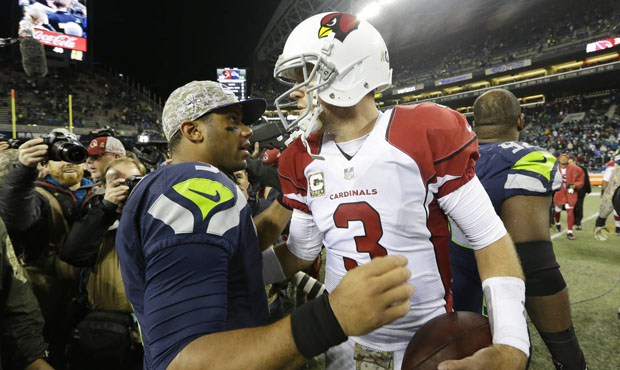 QBs Russell Wilson and Carson Palmer could both end up sitting on the bench at some point Sunday. (...