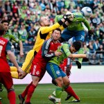 Toronto FC goal keeper Stefan Frei punches the ball out of the box as Sounder defender Jhon Kennedy Hurtado attempts to get a header.