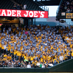 Fans seated in the King's Court section show their support for Mariners pitcher Felix Hernandez as he goes up to bat during the third inning. 