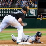 Mariners second baseman Dustin Ackley dives back to first base safely on a pick off throw by Marlins pitcher Mike Dunn.
