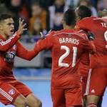 
              FC Dallas' Mauro Diaz, left, rushes to join teammates Michael Barrios (21) and David Texeira (9) in celebrating after Dallas' Fabian Castillo scored a goal against the Seattle Sounders in the first half of an MLS soccer western conference semifinal playoff match, Sunday, Nov. 1, 2015, in Seattle. (AP Photo/Ted S. Warren)
            