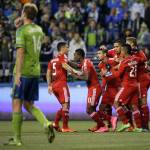 
              Seattle Sounders' Chad Marshall, left, walks to the center of the field as FC Dallas players celebrate after Dallas' Fabian Castillo, third from left, scored a goal in the first half of an MLS soccer western conference semifinal playoff match, Sunday, Nov. 1, 2015, in Seattle. (AP Photo/Ted S. Warren)
            