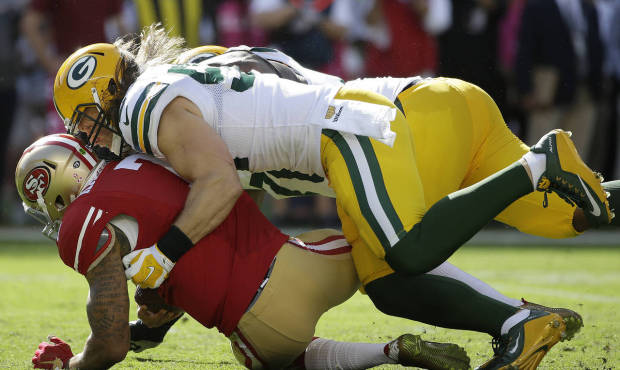 Green Bay Packers outside linebacker Clay Matthews, top, sacks San Francisco 49ers quarterback Coli...