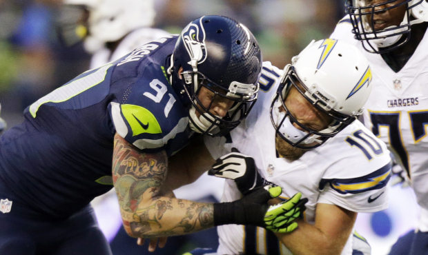 Seattle Seahawks defensive end Cassius Marsh (91) puts a hit on San Diego Chargers quarterback Kell...