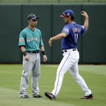 
              Texas Rangers pitcher Yu Darvish (11) and Seattle Mariners right fielder Nori Aoki talk in the outfield before a spring training baseball game Sunday, March 6, 2016, in Surprise, Ariz. (AP Photo/Charlie Riedel)
            