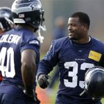 Seattle Seahawks running back Christine Michael (33) holds his helmet during warmups, Wednesday, Jan. 15, 2014, before NFL football practice in Renton, Wash. The Seahawks will play the San Francisco 49ers Sunday in the NFC championship. (AP Photo/Ted S. Warren)