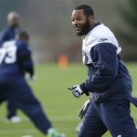 Seattle Seahawks defensive end Michael Bennett walks on the field during warmups before NFL football practice on Wednesday, Jan. 15, 2014, in Renton, Wash. (AP Photo/Ted S. Warren)