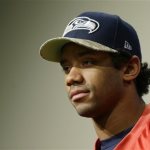 Seattle Seahawks quarterback Russell Wilson talks to reporters, Wednesday, Jan. 15, 2014, in Renton, Wash. The Seahawks will play the San Francisco 49ers Sunday in the NFL football NFC championship in Seattle. (AP Photo/Ted S. Warren)